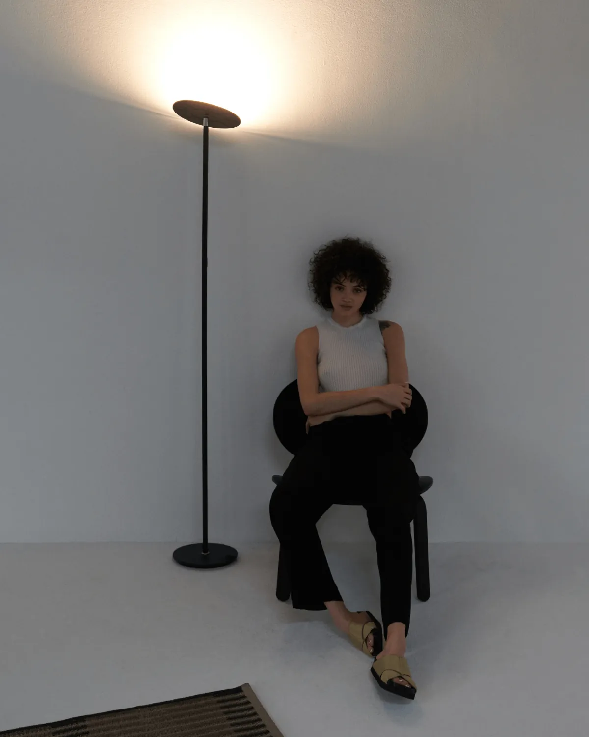 Task lamp beside a chair where a torchiere is the wrong pick